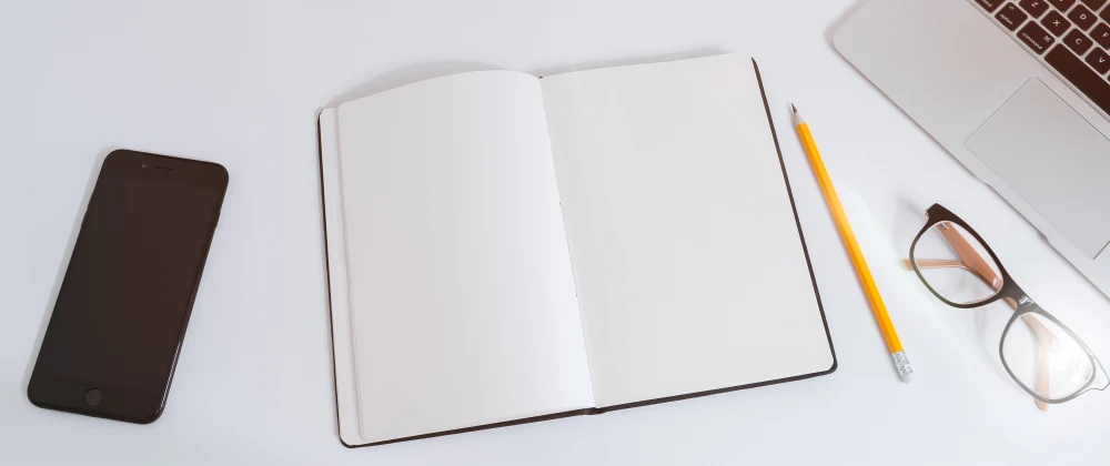 Featured image of a desk with notebook, phone, and pencil